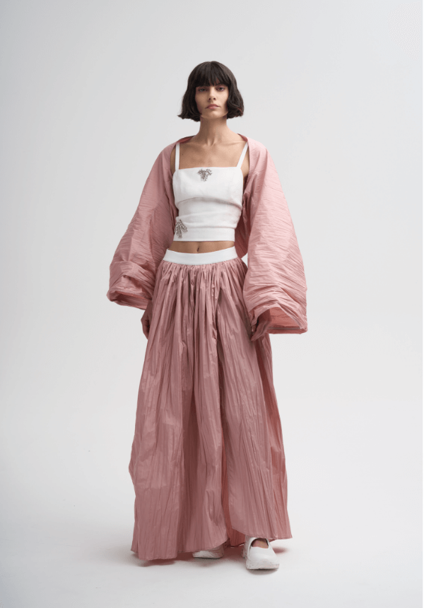 womanswear white top and long pink skirt
