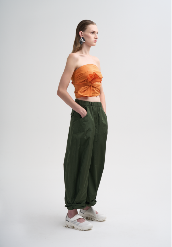 womanswear orange top and green pants