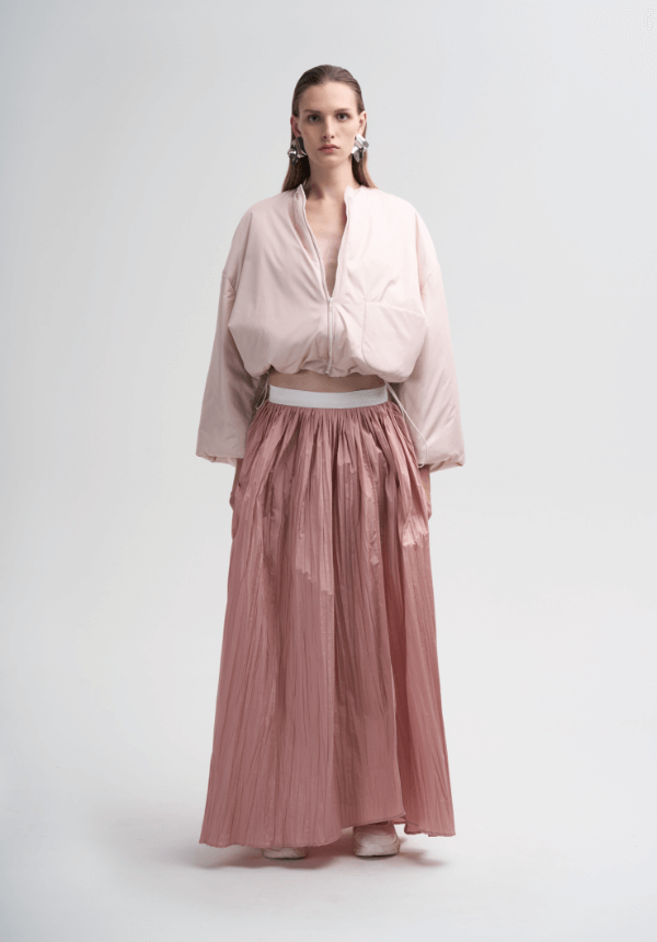 woman pink skirt and padded jacket