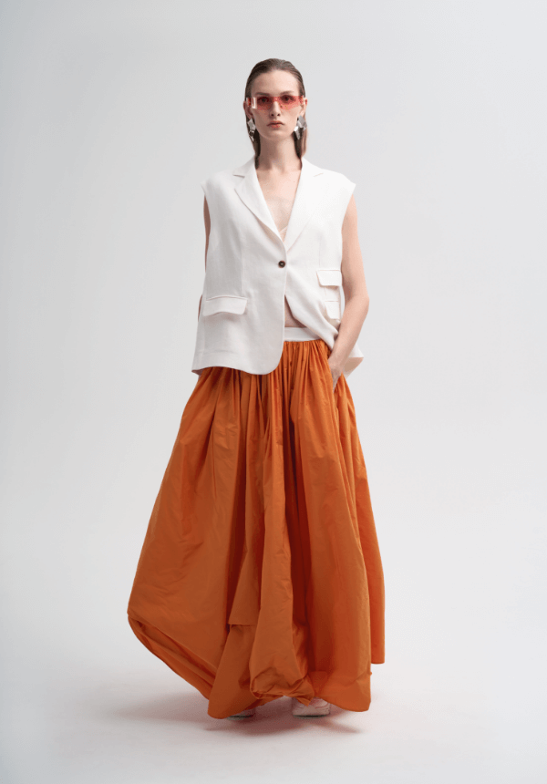 long orange skirt and white sleeveless top